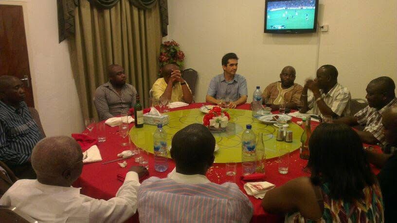 Group seated around a table at an archival media monitoring meeting